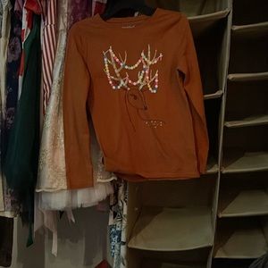 Selling a brown shirt with a reindeer on it and lights on it
